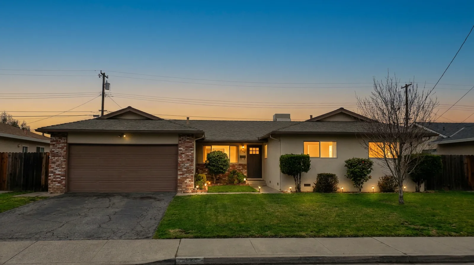 The same house at twilight — relit, wires and car removed, windows glowing (AI-generated demo)